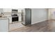 Open concept kitchen and living area with stainless steel appliances and hardwood floors at 4485 17Th W St, Bradenton, FL 34207