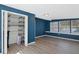 Sunroom with built-in shelving and wood-look floors at 4485 17Th W St, Bradenton, FL 34207