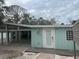 Light teal single story home with a deck and walkway at 4510 Banan Pl, Sarasota, FL 34242