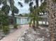 Pathway to teal cottage surrounded by palm trees at 4510 Banan Pl, Sarasota, FL 34242