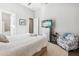 Spacious bedroom with hardwood floors, light wood furniture and en-suite bathroom at 4745 Benito Ct, Lakewood Ranch, FL 34211