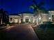 Night view of home's exterior, showcasing landscaping and lighting at 4745 Benito Ct, Lakewood Ranch, FL 34211