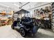 Spacious garage with golf cart, shelving, and ample storage at 4745 Benito Ct, Lakewood Ranch, FL 34211