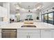 Kitchen island with sink and dishwasher, open to living room at 4745 Benito Ct, Lakewood Ranch, FL 34211