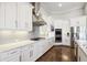 White kitchen with stainless steel appliances and gas cooktop at 4745 Benito Ct, Bradenton, FL 34211