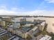 Aerial view of waterfront community with multiple buildings, pool, and tennis courts at 4775 Cove Cir # 202, St Petersburg, FL 33708