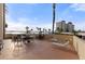 Private balcony with table and chairs, lounge chairs, and waterfront view at 4775 Cove Cir # 202, St Petersburg, FL 33708