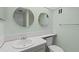 Updated bathroom with a single sink vanity, toilet and large vanity mirrors at 4775 Cove Cir # 202, St Petersburg, FL 33708