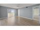 Bedroom with wood-look floors, access to balcony, and ceiling fan at 4775 Cove Cir # 202, St Petersburg, FL 33708
