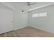 Bright bedroom with wood-look floors and ceiling fan at 4775 Cove Cir # 202, St Petersburg, FL 33708