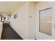 Condo hallway with light walls and a white door at 4775 Cove Cir # 202, St Petersburg, FL 33708