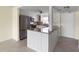Open kitchen with island, stainless steel appliances, and granite countertops at 4775 Cove Cir # 202, St Petersburg, FL 33708