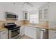 Modern kitchen with stainless steel appliances and granite countertops at 4775 Cove Cir # 202, St Petersburg, FL 33708