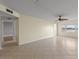 Living room with tile floors, ceiling fan, and hallway access at 4775 Cove Cir # 202, St Petersburg, FL 33708