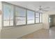 Bright sunroom with water views and ceiling fan at 4775 Cove Cir # 202, St Petersburg, FL 33708