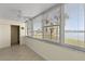 Sunroom with water views, tile floors, and ceiling fan at 4775 Cove Cir # 202, St Petersburg, FL 33708