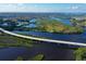 Panoramic aerial view of community, with bridge over waterways amid lush landscaping, showcasing the coastal lifestyle at 505 Sand Crane Ct, Bradenton, FL 34212