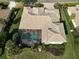 Overhead view of home featuring a screened-in pool, tile roof, and expansive backyard at 505 Sand Crane Ct, Bradenton, FL 34212