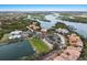 Aerial view of resort with golf course, marina, and residences along scenic waterways, a luxurious coastal retreat at 505 Sand Crane Ct, Bradenton, FL 34212