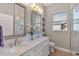 Bright bathroom features double vanity sinks with marble countertop, tile floor, and a glass shower at 505 Sand Crane Ct, Bradenton, FL 34212