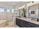 Bathroom features double vanity, bathtub, tiled shower with glass door and natural light at 505 Sand Crane Ct, Bradenton, FL 34212