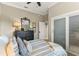 Bedroom features a dark dresser, comfortable queen bed, and a sliding door closet at 505 Sand Crane Ct, Bradenton, FL 34212