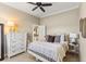 Bright bedroom with carpet, crown molding, ceiling fan, and furniture in the foreground at 505 Sand Crane Ct, Bradenton, FL 34212
