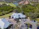 Aerial view of the clubhouse and golf course, with ample parking, amid lush green fairways at 505 Sand Crane Ct, Bradenton, FL 34212
