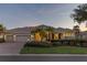 Stunning single-story home with a three-car garage and beautiful landscaping, showcasing its curb appeal at 505 Sand Crane Ct, Bradenton, FL 34212