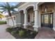 Charming front porch with decorative columns, seating, and a stylish front door, creating a welcoming entrance at 505 Sand Crane Ct, Bradenton, FL 34212
