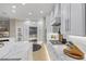 Modern kitchen featuring white cabinets, stainless steel appliances, and a view into the living room at 505 Sand Crane Ct, Bradenton, FL 34212