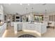 Bright, open kitchen with a large island, stainless steel appliances, and seamless flow to the living area at 505 Sand Crane Ct, Bradenton, FL 34212