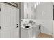 Well-lit laundry room featuring white cabinetry, subway tile backsplash, modern black faucet, and high-efficiency washer and dryer at 505 Sand Crane Ct, Bradenton, FL 34212