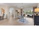 Inviting living room with tile flooring, neutral decor, and seamless access to the outdoor pool area at 505 Sand Crane Ct, Bradenton, FL 34212