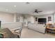 Carpeted living room with ceiling fan, television, multiple sofas, and neutral color scheme at 505 Sand Crane Ct, Bradenton, FL 34212