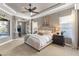 Spacious main bedroom featuring carpet floors, a ceiling fan, and views of the pool area at 505 Sand Crane Ct, Bradenton, FL 34212