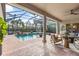 Inviting outdoor living space with a covered patio, screened-in pool, and lush landscaping for entertaining at 505 Sand Crane Ct, Bradenton, FL 34212