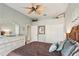 Spacious bedroom with dresser, ceiling fan and large closet at 5112 White Ibis Dr, North Port, FL 34287