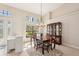 Bright dining room with large windows and wood furnishings at 5112 White Ibis Dr, North Port, FL 34287