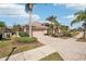 One-story home with tile roof, two-car garage, and palm trees at 5112 White Ibis Dr, North Port, FL 34287