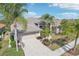One-story home with tile roof, two-car garage, and palm trees at 5112 White Ibis Dr, North Port, FL 34287