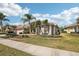 Tan house with palm trees and manicured lawn at 5112 White Ibis Dr, North Port, FL 34287