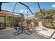 Spacious screened lanai with seating and outdoor dining area at 5112 White Ibis Dr, North Port, FL 34287