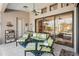 Relaxing outdoor patio with seating area and ceiling fan at 5112 White Ibis Dr, North Port, FL 34287
