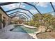 Relaxing pool area with screened enclosure and waterfall feature at 5112 White Ibis Dr, North Port, FL 34287