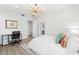 Bright bedroom with a queen bed, workspace, and modern chandelier at 5235 Siesta Cove Dr, Sarasota, FL 34242