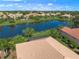 Aerial view of home community with lake and lush landscaping at 531 Latitude Ln, Osprey, FL 34229