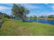 Picturesque backyard with lush landscaping and a serene lake view at 531 Latitude Ln, Osprey, FL 34229