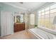 Spa-like bathroom with soaking tub, walk-in shower, and double vanity at 531 Latitude Ln, Osprey, FL 34229