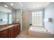 Spa-like bathroom with a soaking tub, walk-in shower, and granite vanity at 531 Latitude Ln, Osprey, FL 34229